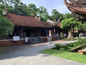 建物は、赤い瓦屋根を持つ伝統的な木造建築である。]